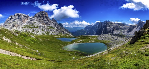 Alpine Landscape With Mountain Peaks And Clear Lakes At The Formation Tre Cime Di Lavaredo In The