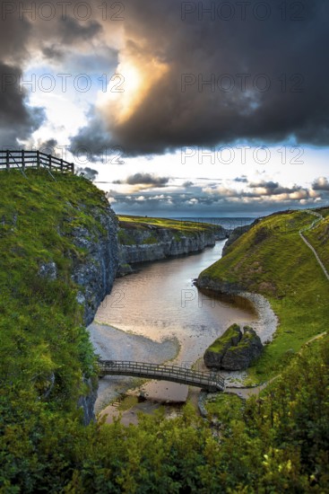 Canyon And Entrance With Bridge To Smoo Cave And Atlantic Coast At Sunset Near Durness In Scotland,