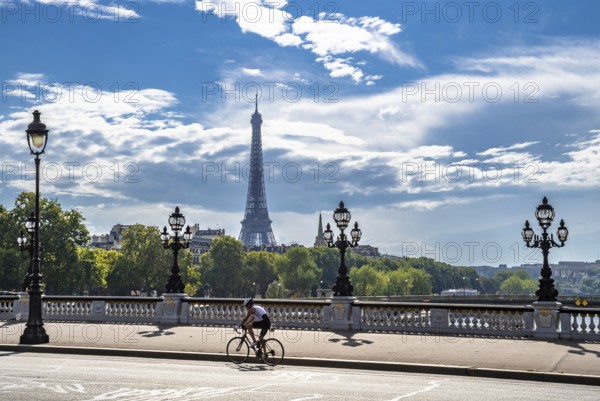 Bridge Pont Alexandre III Over River Seine With Single Bicycle Rider And View To Eiffel Tower In