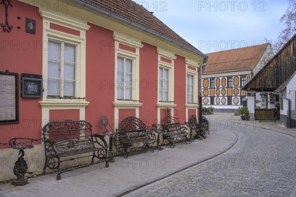Alley in the old town centre with wrought-iron benches made from old metal parts, Varaždin,