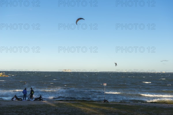 Kitesurfing in the Bay of Kiel in strong winds, high swell, Big Air Jump, Strande near Kiel,