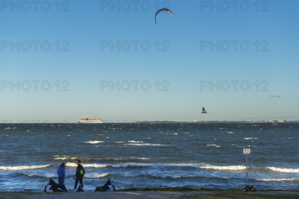 Kitesurfing in the Bay of Kiel in strong winds, high swell, Big Air Jump, Strande near Kiel,