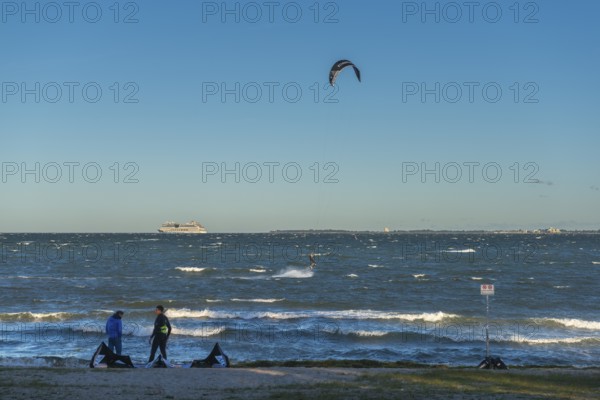 Kitesurfing in the Bay of Kiel in strong winds, high swell, Strande near Kiel,