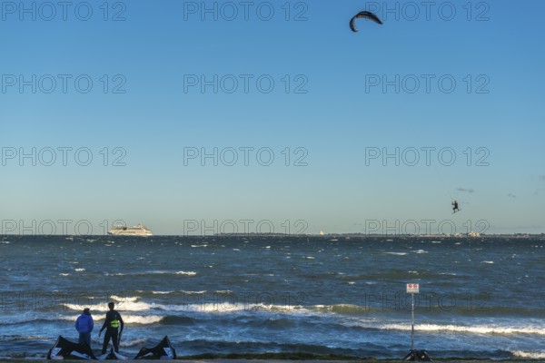 Kitesurfing in the Bay of Kiel in strong winds, high swell, Big Air Jump, Strande near Kiel,