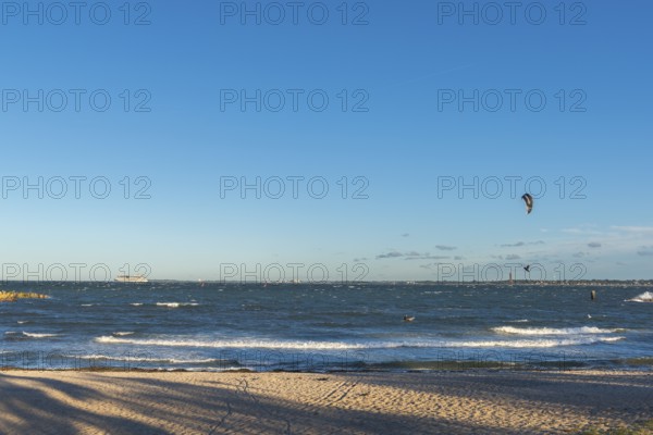 Kitesurfing in the Bay of Kiel in strong winds, high swell, Big Air Jump, Strande near Kiel,