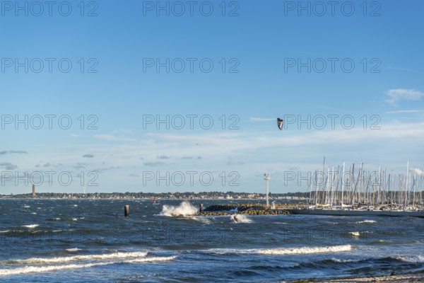 Kitesurfing in the Bay of Kiel in strong winds, high swell, Strande near Kiel,