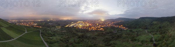 Dusk over an illuminated town, surrounded by vineyards and orchards, Korb and Kleinheppach in the