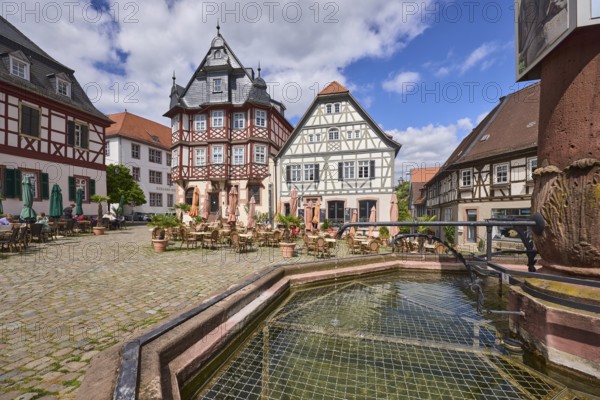 Old town, stone fountain, water, historic half-timbered houses, cobblestone square, outdoor area of