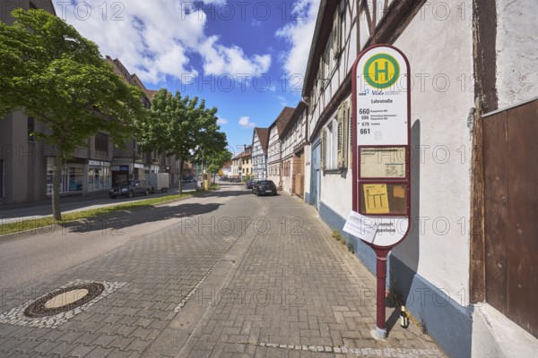 Bus stop Lehrstraße, half-timbered houses, general architecture, street, trees, car park with