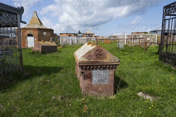 An old cemetery with decorated gravestones and inscriptions on a green meadow, Gravestone,