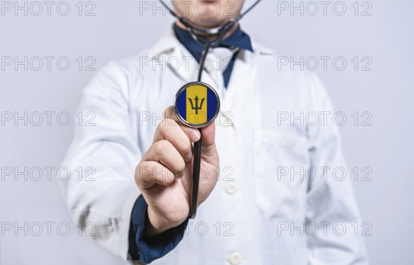 Doctor hands holding stethoscope with Barbados flag. Barbados health and care concept