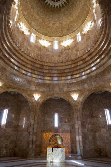 An interior with a domed golden dome and impressive pillars of light that create a majestic