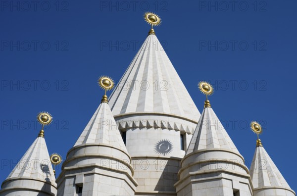 White architectural church tower with geometric shapes against a blue sky, Yazidi temple, Yazidi