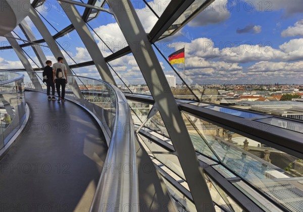 Interior view of the Reichstag dome with visitors and the German flag, Reichstag building,