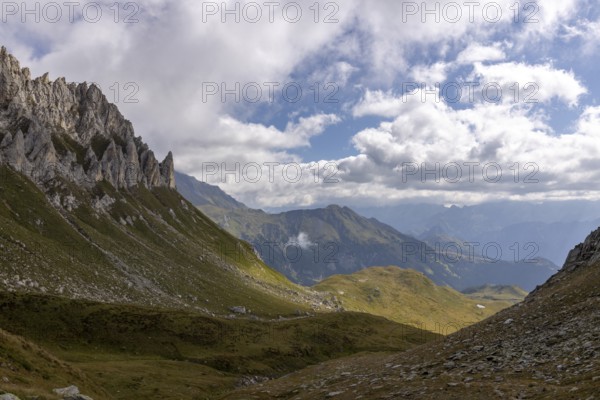 View from Passo del Sole towards Blenio Valley and Lukmanier, on the left steep rock faces at