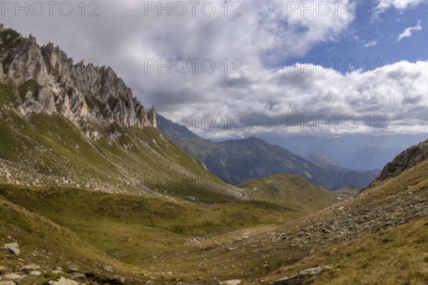 View from Passo del Sole towards Lukmanier and Blenio Valley, on the left steep rock faces at