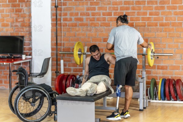 Man with prosthetic leg spotting another man with leg injuries or absence, who struggles with a