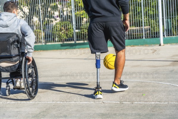 Young men with disabilities enjoying a basketball game together on an outdoor court, embracing