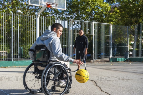 Two men experiencing disabilities, one in a wheelchair and another with a prosthetic leg, are