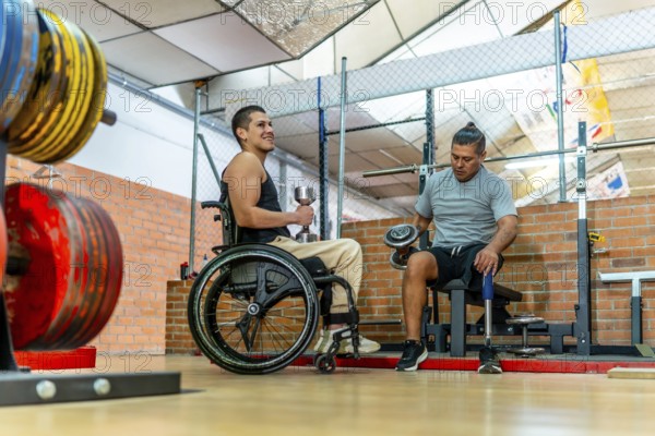 Two men with disabilities training together in a gymone in a wheelchair, one with a prosthetic