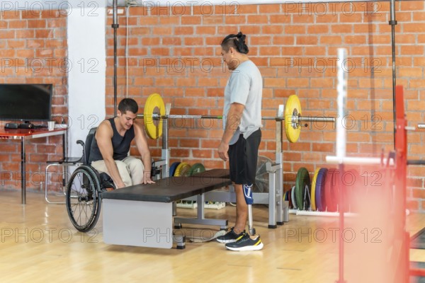 Adapted athletes focusing on their fitness routine at a gym, with one man using a wheelchair and