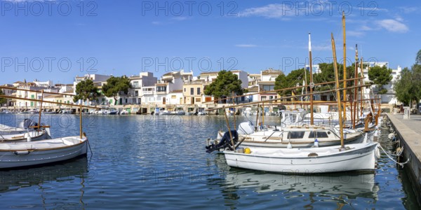 Portocolom fishing village on Majorca with boats and colourful houses Holiday by the sea Panorama