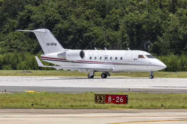 A Bombardier Challenger 604 private jet aircraft with the registration XA-OFM at San Juan Airport,