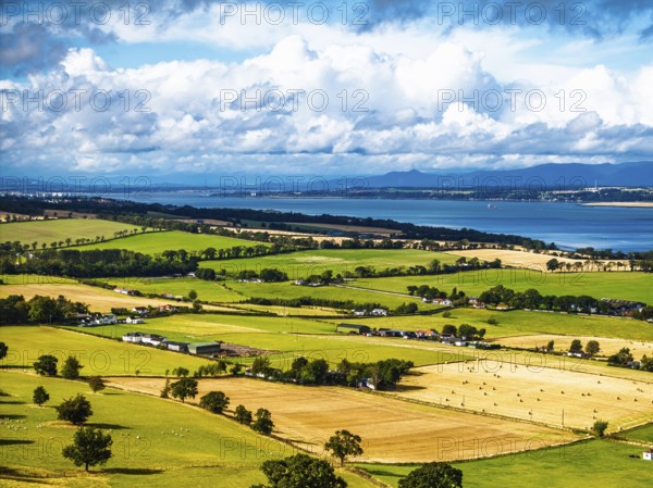 Fields and farms over Scotish farms and Forth Estuary from drone, House of the Binns, Binns Tower,