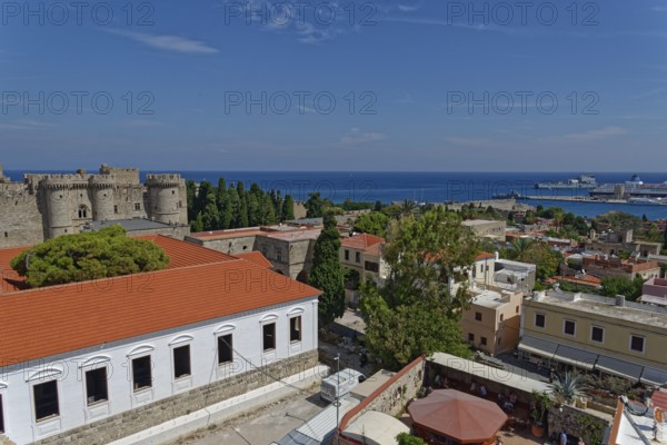 View of a historic town with castle, red roofs and sea in the background, Medieval Town of Rhodes,