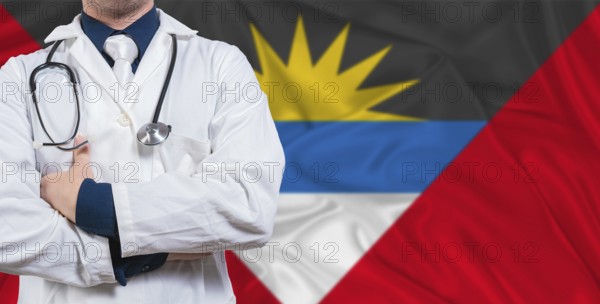 Male doctor with stethoscope on Antigua and Barbuda flag. Doctor holding stethoscope on Antigua and