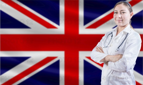 Female doctor on United Kingdom flag. Doctor with crossed arms on United Kingdom flag. United