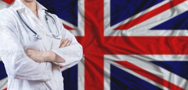 Doctor with crossed arms on United Kingdom flag. United Kingdom health and care concept. Female