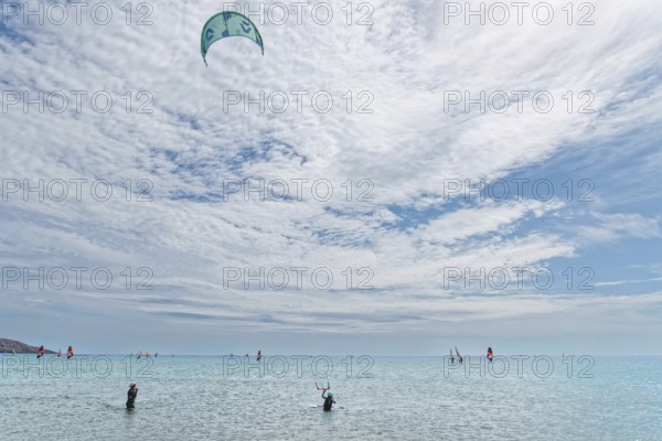 Prasonisi's expansive sea under a big sky with kitesurfers. Lively, sporty atmosphere, Prasonisi,