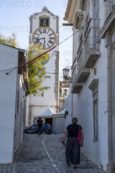 Old town alleys, catholic church Igreja de Santa Maria do Castelo in Tavira, in the Algarve,
