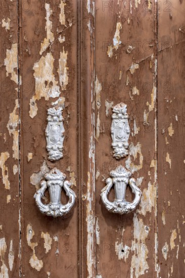 The old town centre of Tavira, typical door knockers found on many wooden doors in the town,