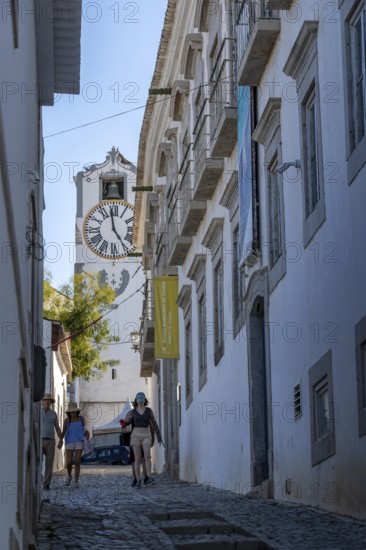 Old town alleys, catholic church Igreja de Santa Maria do Castelo in Tavira, in the Algarve,