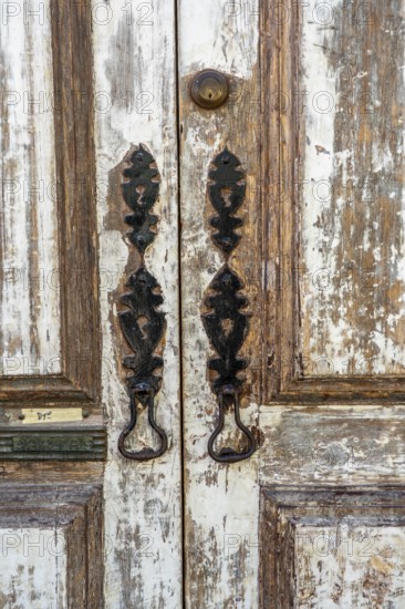 The old town centre of Tavira, typical door knockers found on many wooden doors in the town,