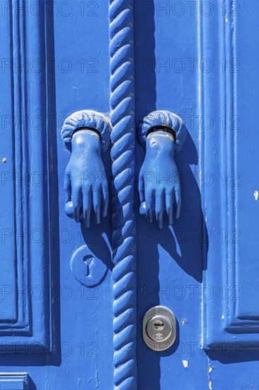 The old town centre of Tavira, typical door knockers found on many wooden doors in the town,