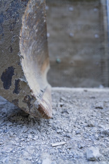 Close-up of a worn shovel on ballast in a construction site environment, Hermann Hessebahn