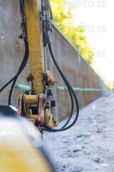 Close-up of a construction machine with hoses on a construction wall, Hermann Hessebahn