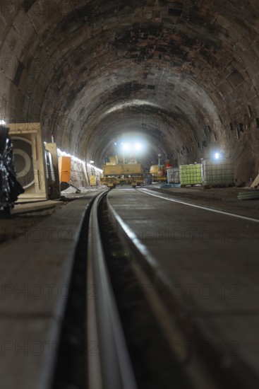 Rail construction in the tunnel with machines and equipment placed on the sides, construction of