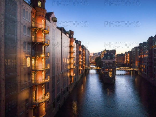 Evening view of the Hamburg warehouse district with a view of the moated castle from