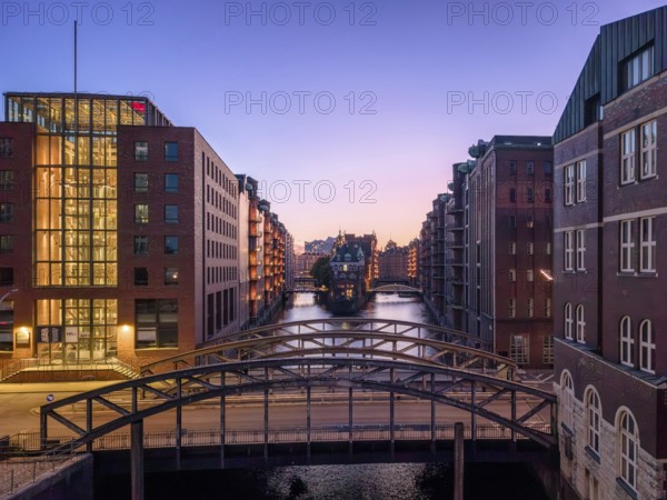 Evening shot of Hamburg's Speicherstadt warehouse district with a view of the moated castle and the