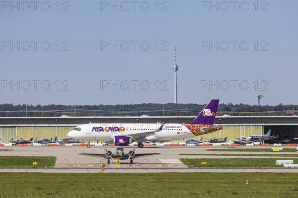 Stuttgart Airport with television tower and aeroplane on the runway. Aircraft registration: SU-BVN,