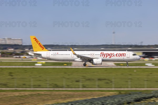 Stuttgart Airport with television tower and aeroplane on the runway. Aircraft registration number: