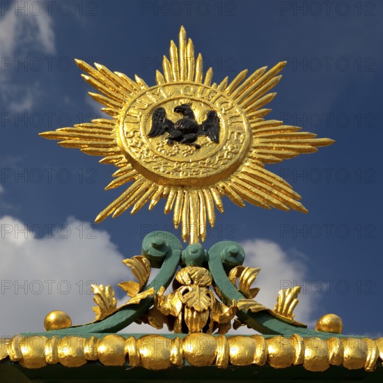 Golden star with black eagle and the Latin inscription suum cuique, to each his own, detail on the