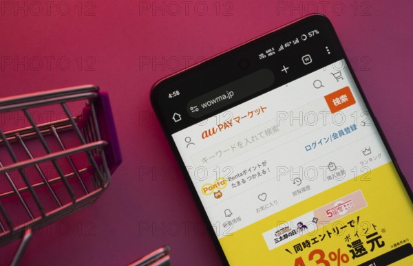 Dhaka, Bangladesh- 23 June 2025: A smartphone displaying the wowma website with a shopping cart is
