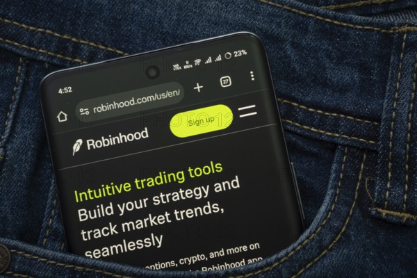 Dhaka, Bangladesh- 15 June 2025: A smartphone displaying the Robinhood web interface peeks out of a