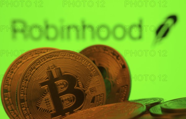 Dhaka, Bangladesh- 20 Sep 2025: Close-up of Bitcoin coins with the Robinhood Markets logo visible