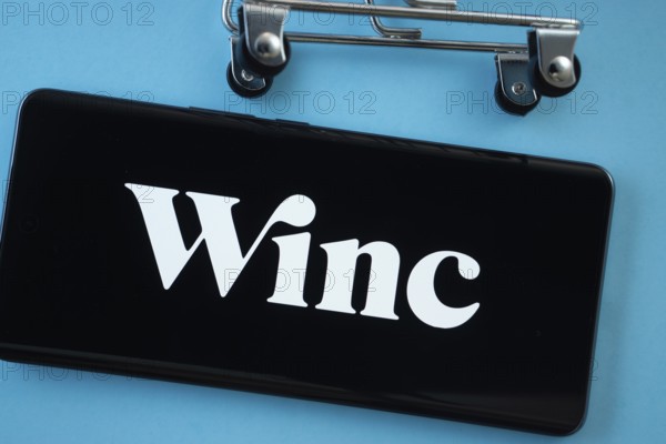 Dhaka, Bangladesh- 03 July 2025: Smartphone screen showing the Winc logo with shopping cart wheels